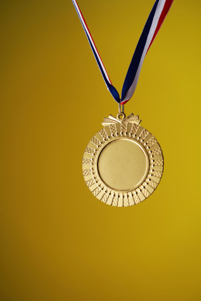 带有复制空间的黄色背景的金色奖章图片下载