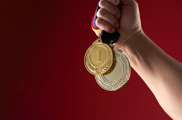 手拿金牌对红色背景图片下载