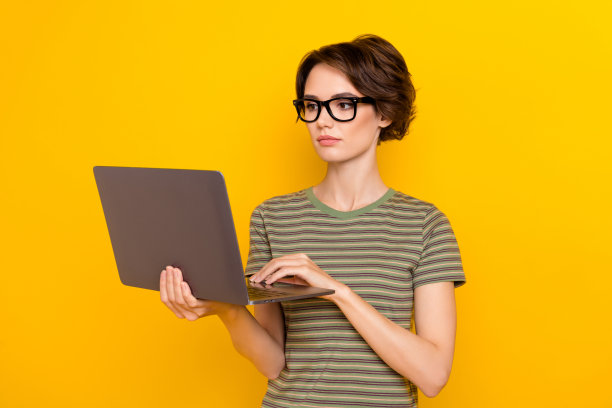 严肃自信的女孩的照片穿着绿色t恤眼镜聊天现代小玩意孤立的黄色背景图片下载