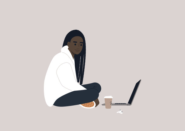 一个年轻的非洲女性角色盘腿坐在地板上，在笔记本电脑上工作图片下载