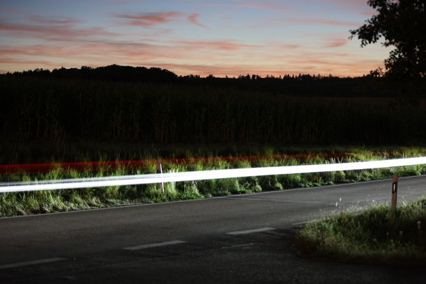 光线在黑暗的夜晚，汽车大灯上的光圈很长图片下载