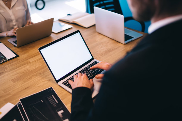 一个陌生男子在笔记本电脑上打字图片下载