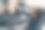 兴奋的女人戴着VR头盔和笔记本电脑，用手触摸空气，坐在咖啡厅的扶手椅上图片下载