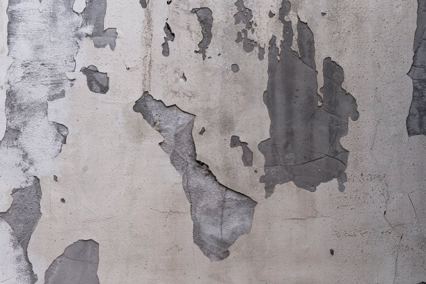 特写的建筑外立面上覆盖着灰泥和油漆的裂缝。图片下载