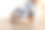 7个月大的多指畸形男孩穿着中性颜色可重复使用的布尿布学习一种新的发育技能:自己坐起来图片下载