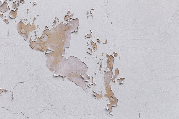 特写的建筑外立面上覆盖着灰泥和油漆的裂缝。图片下载