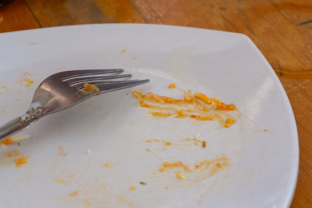 饭后把盘子弄脏。餐后盘子脏，食物未吃完的概念图片下载