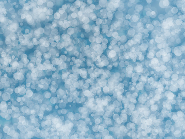 抽象的散焦淡蓝色渐变色背景与散焦圆灯的圣诞主题或夏季假期的设计概念图片下载