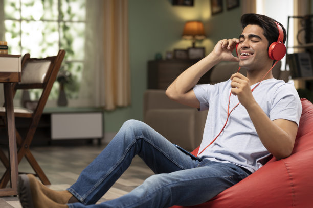 年轻人在家听音乐，库存照片图片下载