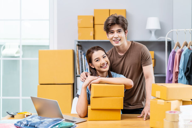 年轻的亚洲夫妇在内部办公室工作，看起来像是在创业，微笑着开心和积极，夫妇成功的惊喜，使他的网上商店大销售。图片下载