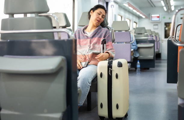 年轻女乘客在城市列车上睡觉图片下载