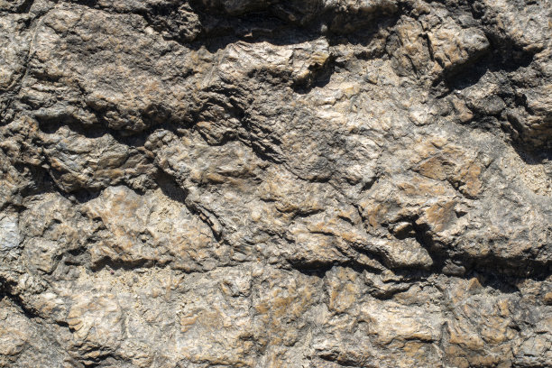 原始花岗岩岩石纹理背景。天然石墙碎片。图片下载