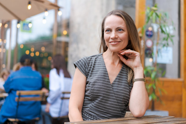 肖像白人妇女坐在椅子上的咖啡馆在情感幸福的微笑图片下载