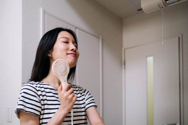 用手扇降温的女人图片下载