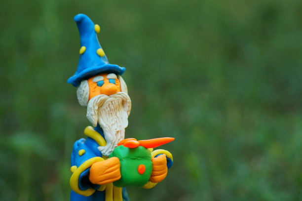 一个带着礼品盒的玩具巫师。一个生日礼物。图片下载