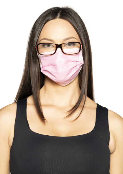 戴着医用口罩和眼镜的漂亮年轻女子图片下载