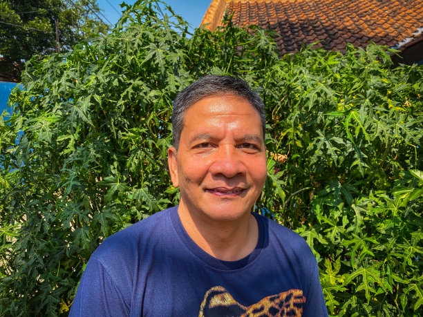 印度尼西亚中年男子在花园里微笑的照片图片下载