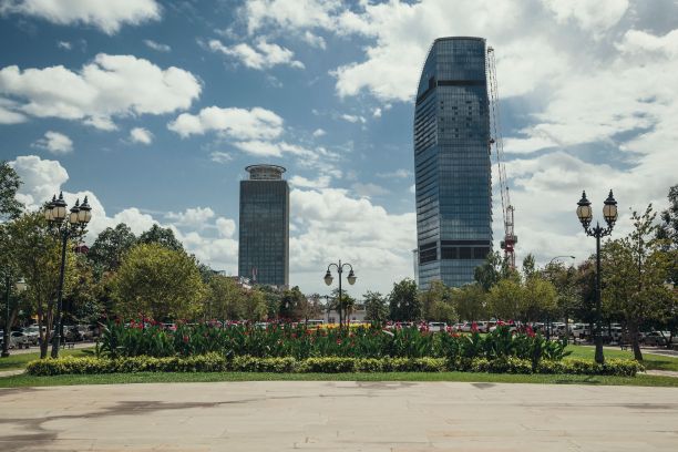 柬埔寨漂亮的玻璃摩天大楼，前景中有一个花坛图片下载