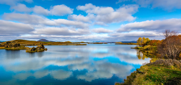 欧洲冰岛米瓦坦湖上令人惊叹的阳光灿烂的一天。美丽的云朵倒映在火山湖的蓝色水面上。艺术照片。美丽的世界。旅行的概念。全景图片下载
