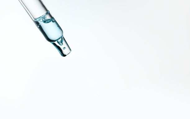 带透明质酸的吸管，蓝色背景。化妆品和保健概念特写图片下载