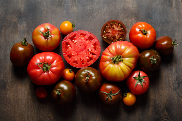 新鲜的祖传品种西红柿在黑暗的木制背景。秋天,丰收。以番茄为背景。图片下载