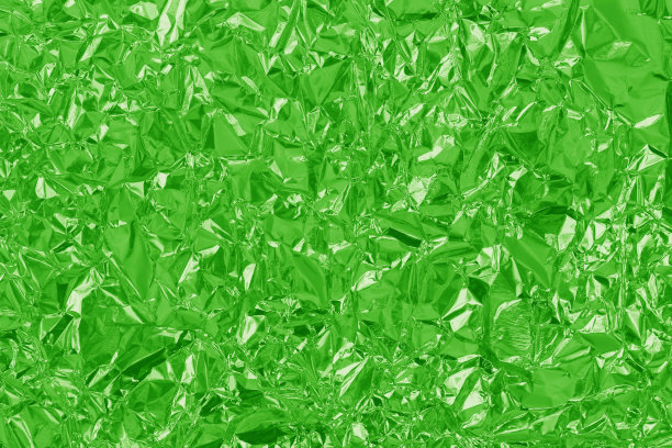绿色石灰箔有光泽的纹理，抽象的包装纸作为背景和设计艺术作品。图片下载