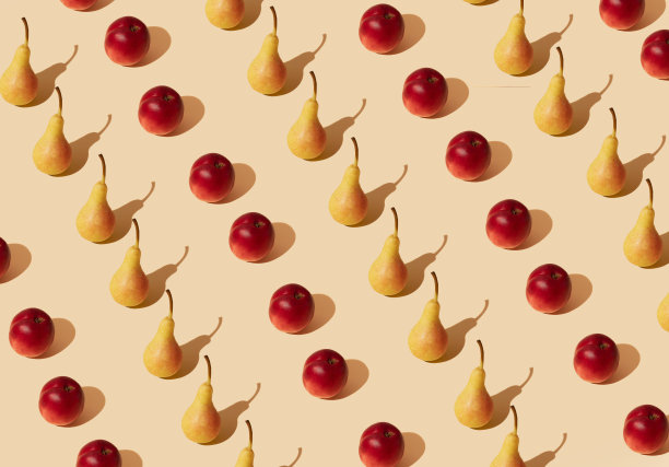 新鲜的黄色梨和桃图案对粉嫩的米色背景。最小的夏季水果布局。图片下载