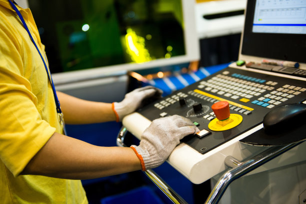 在车间使用数控机床的工人。图片下载