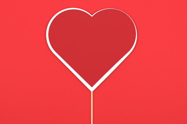 红色背景的空心红心，附在木棒上图片下载