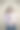 漂亮的年轻妈妈，深色头发，紫色上衣，抱着她7个月大的宝宝，站在棕色背景前图片下载