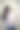 漂亮的年轻妈妈，深色头发，紫色上衣，抱着她7个月大的宝宝，站在棕色背景前图片下载