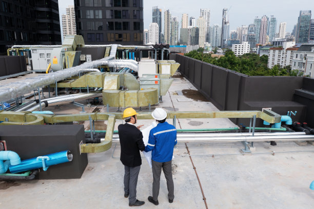 经理拜访在屋顶管架附近工作的工程师，检查进度图片下载