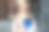 教育的概念。白种金发女学生拿着手机、文件夹、笔记本，看着镜头，在欧洲大学大楼的背景下微笑图片下载
