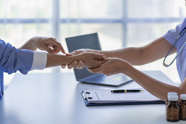 医生和病人通过坐着聊天提供咨询和诊断。在医院的医疗概念台图片下载