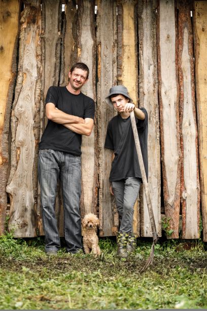 当地农业，10月12日农民节。一个穿着黑色t恤的男人拿着干草叉，用自己的双手制作天然产品。图片下载