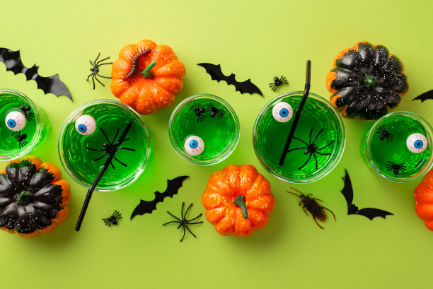 万圣节的概念。俯视图照片绿色浮动眼球穿孔在眼镜蜘蛛蝙蝠剪影南瓜幽灵昆虫蟑螂和蜈蚣孤立的浅绿色背景图片下载