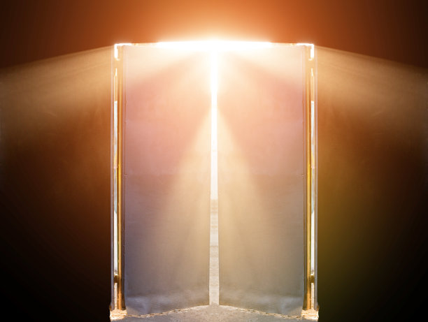 阳光明媚的夏天是室外，温暖温和的阳光透过所有的缝隙和门照射到黑色的房间，照亮房间，门几乎是敞开的图片下载