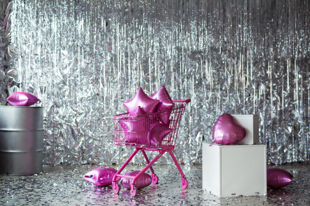 粉红色的购物车里装满了星星气球。创意超市购物车销售概念。购物的象征图片下载