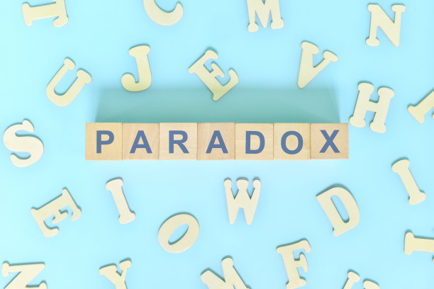 英语语法课中比喻性语言概念的修辞悖论。木块排版平铺在蓝色背景。图片下载