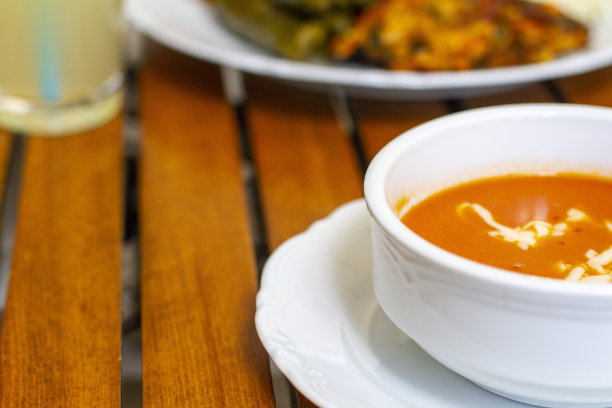 番茄汤与奶酪和地中海橄榄油食物和柠檬水是在木桌水平照片聚焦前景图片下载