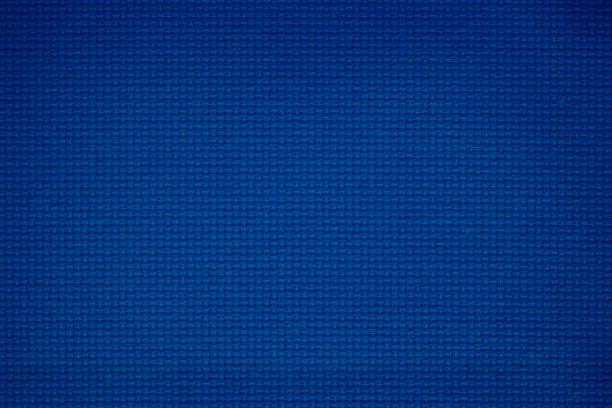 蓝色织物纹理的特写用于背景。图案蓝色深色牛仔布、亚麻、天然棉缎纹织物粗麻布无缝空白。墙纸材料或艺术花边帆布装饰。图片下载