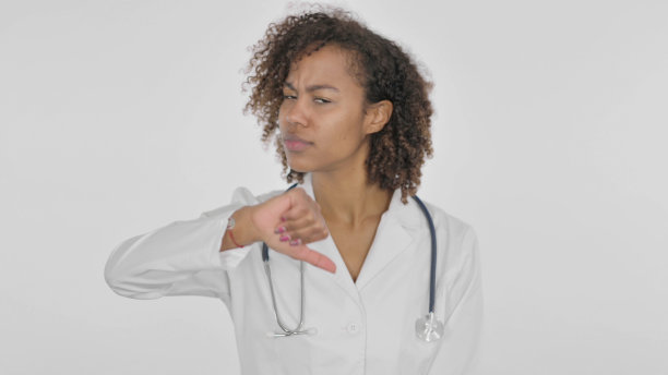 白人背景下的非洲女医生拇指向下的手势图片下载