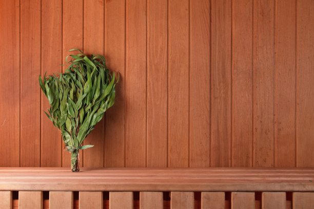 桑拿房的木架子上放着干燥的桉树扫帚。横向设计照片图片下载