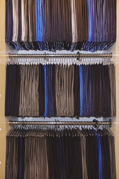 男装店的衣架上挂着许多男士长裤图片下载