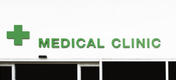 图标绿色交叉与信息医疗诊所在白墙建筑图片下载