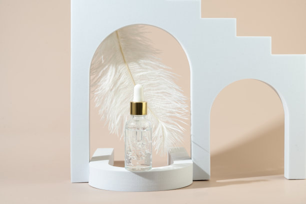 一种透明的天然有机精华液或面部护理精油站在白色拱门在米色背景图片下载