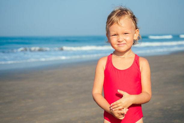 迷人的小女孩在海滩上伤心图片下载