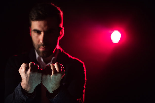 特写照片的男子显示两个拳头在粉红色和黑色的背景。图片下载