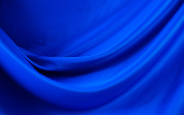 旗帜的抽象织物背景。柔软的丝绸纺织质地在运动的墙纸图片下载