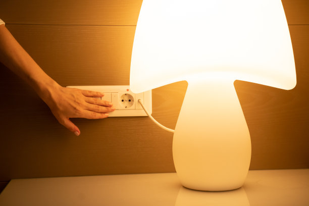 女人的手按白色开关上的按钮来打开灯图片下载